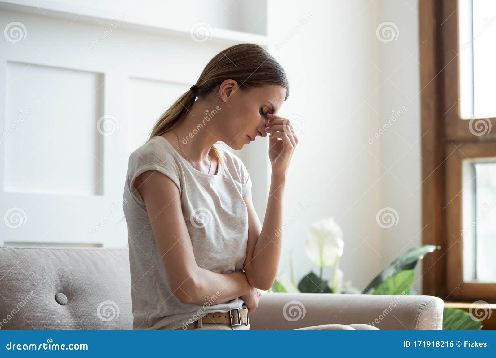 tired young woman massage eyes suffering from migraine