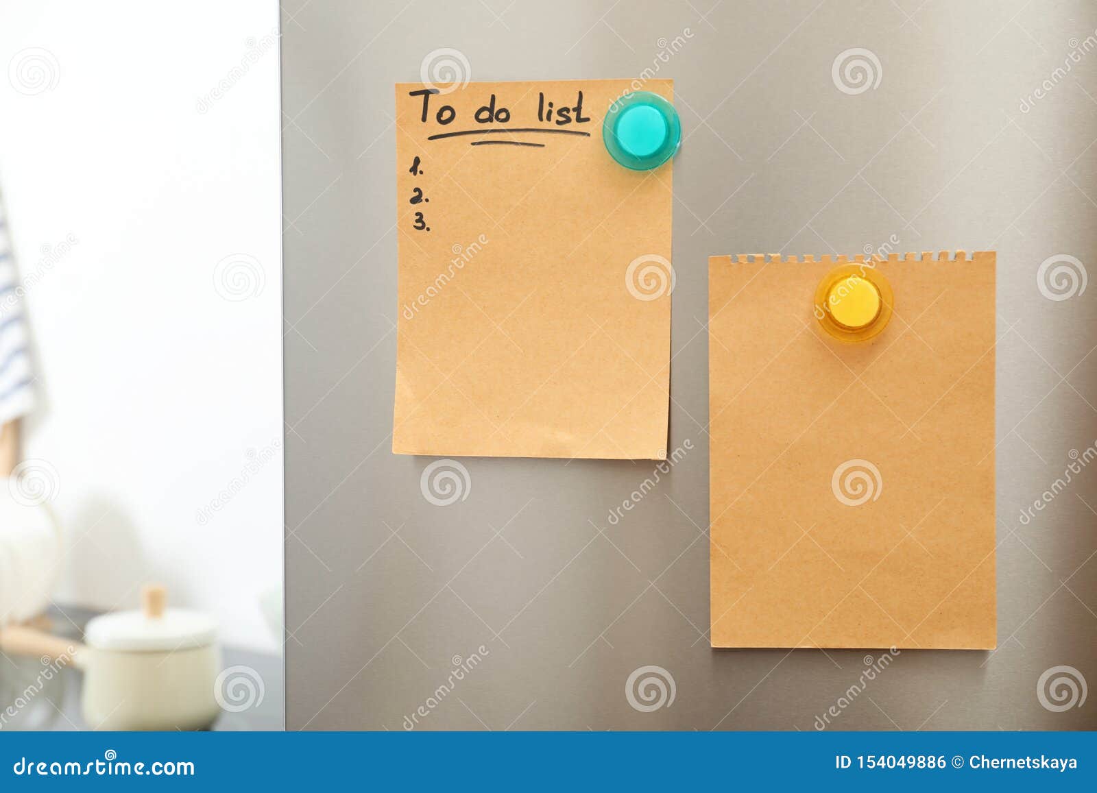 To Do List And Empty Sheet Of Paper With Magnets On Refrigerator