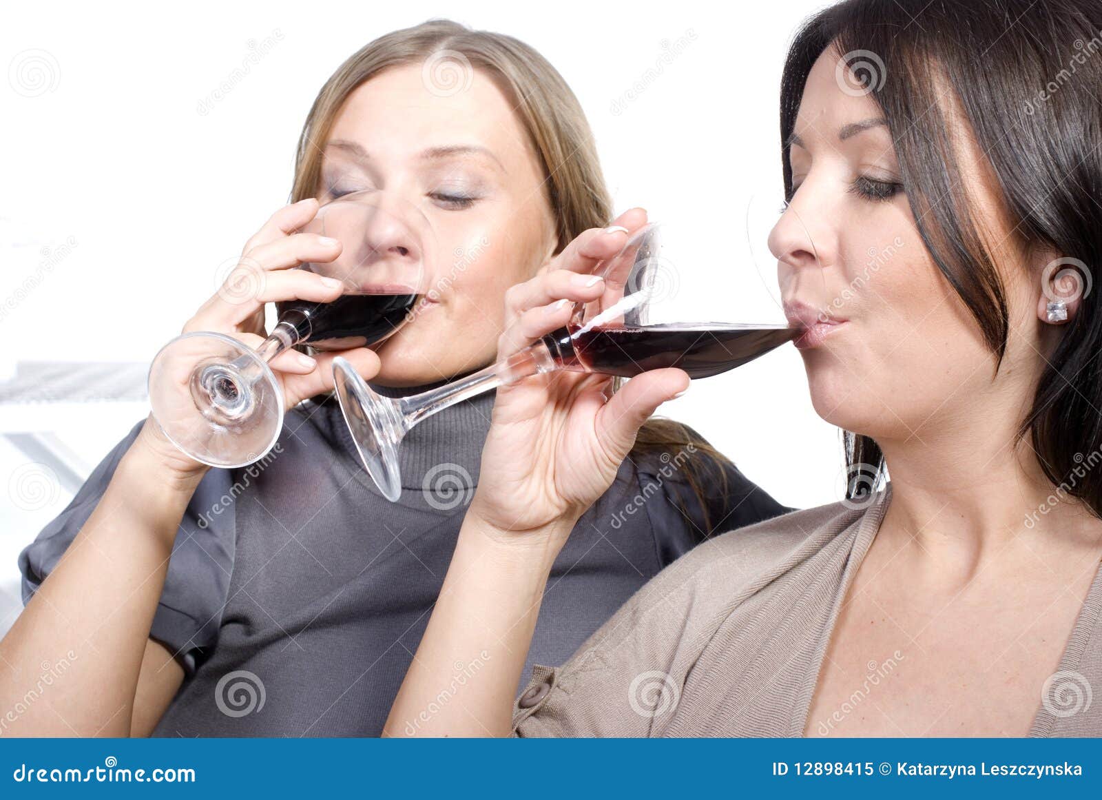 Two businesswomen toasting wine glasses