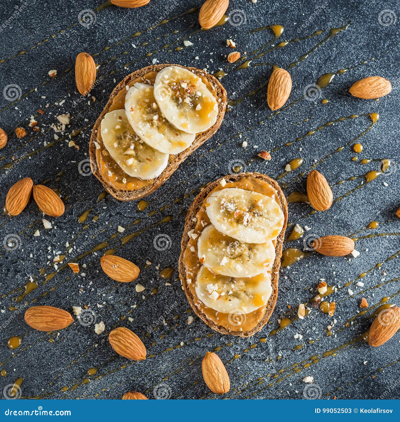 toast with peanut butter, banana and almond nuts. diet natural breakfast. flat lay, top view