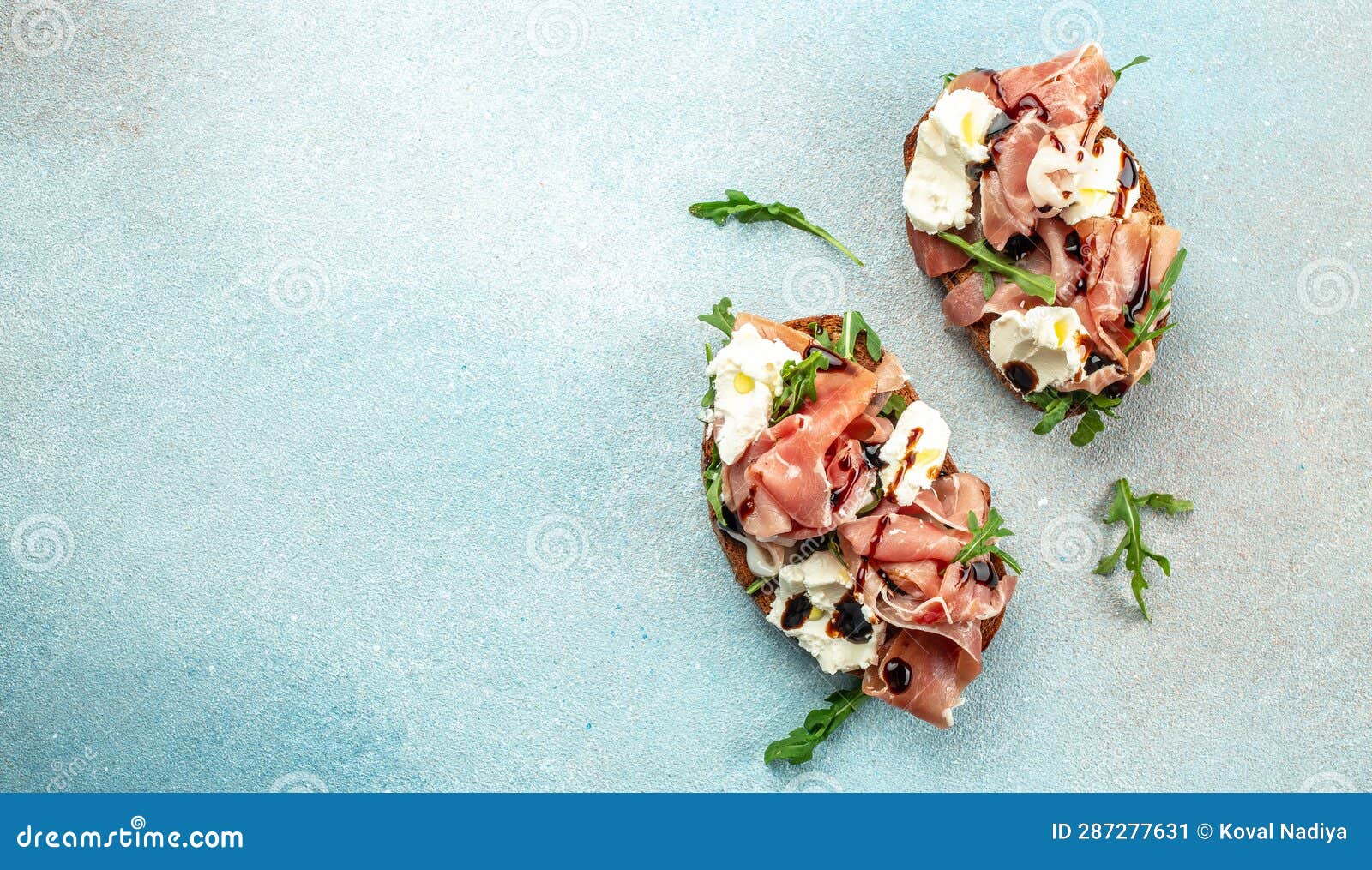 Toast with Prosciutto and Cream Cheese on a Blue Background. Long