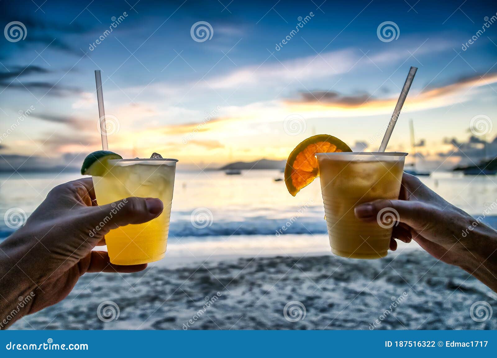 toasting with tropical drinks on the beach.