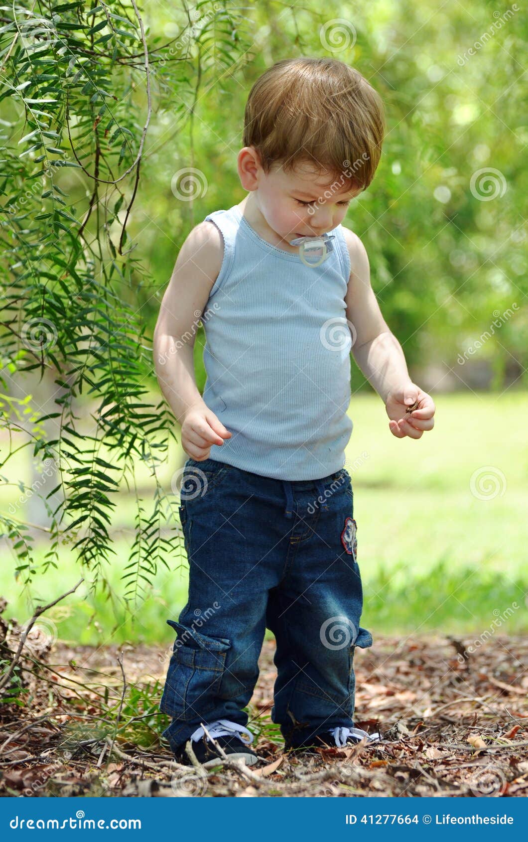 Baby Boy Joyful Laughing & Playing in Country Meadow Stock Image