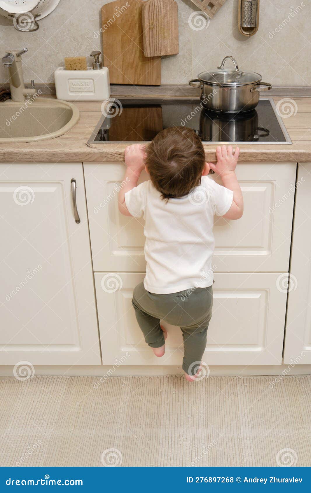 https://thumbs.dreamstime.com/z/toddler-baby-climbs-hot-electric-stove-home-kitchen-small-child-touches-surface-stove-his-hand-276897268.jpg