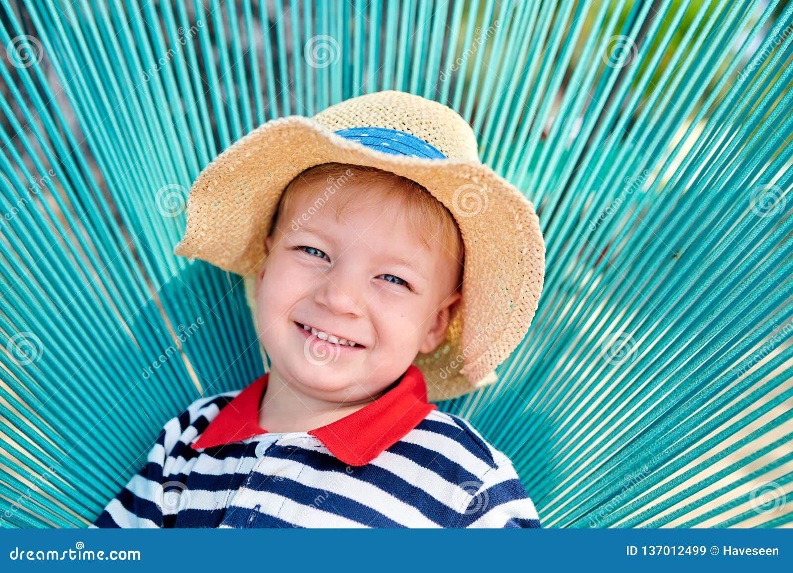 Toddler boy in beach chair stock image. Image of beach 137012499