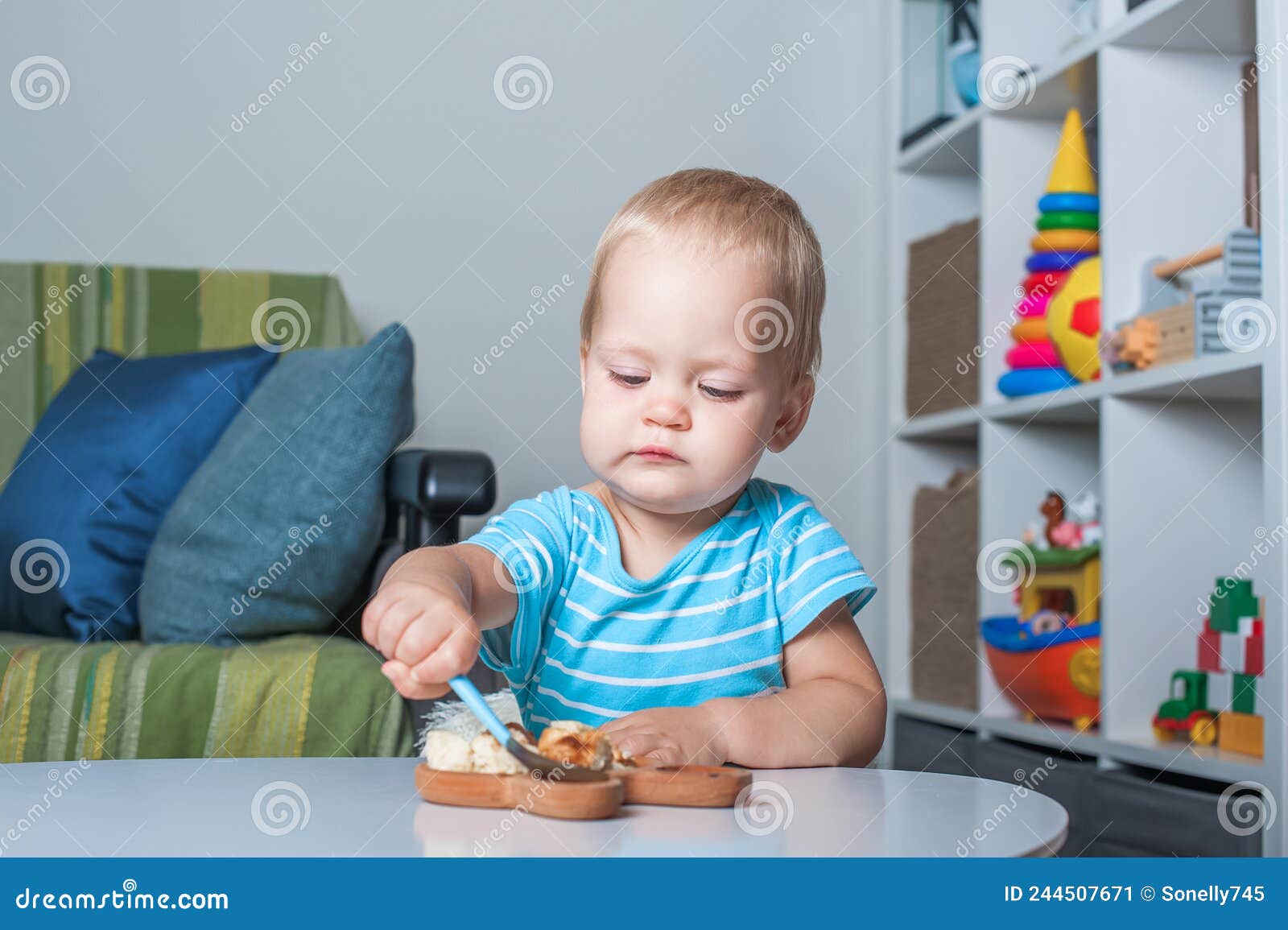 Toddler Boy Eats on His Own at Table at Home.. Stock Image Image of