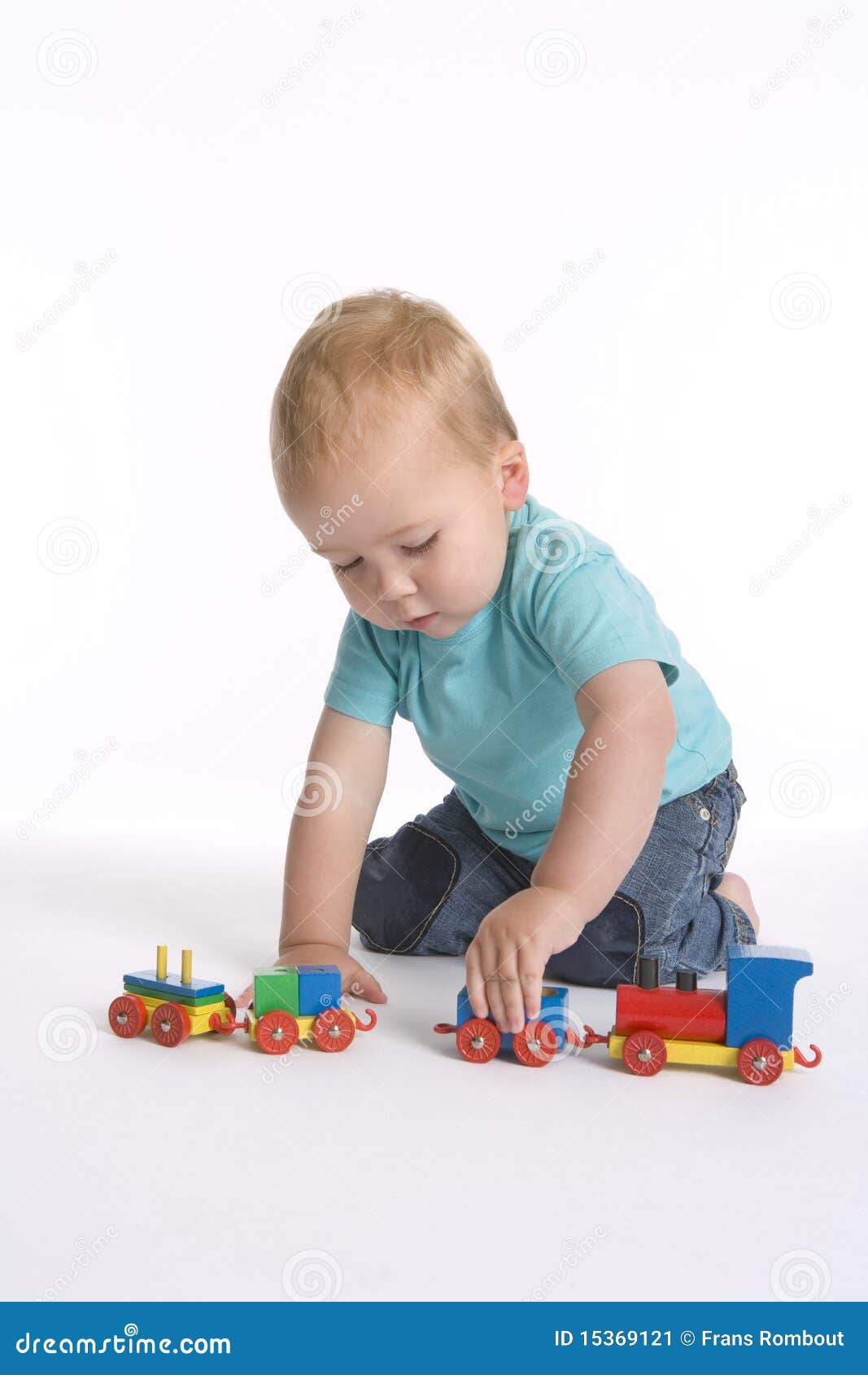 toddler boy playing toy train 15369121