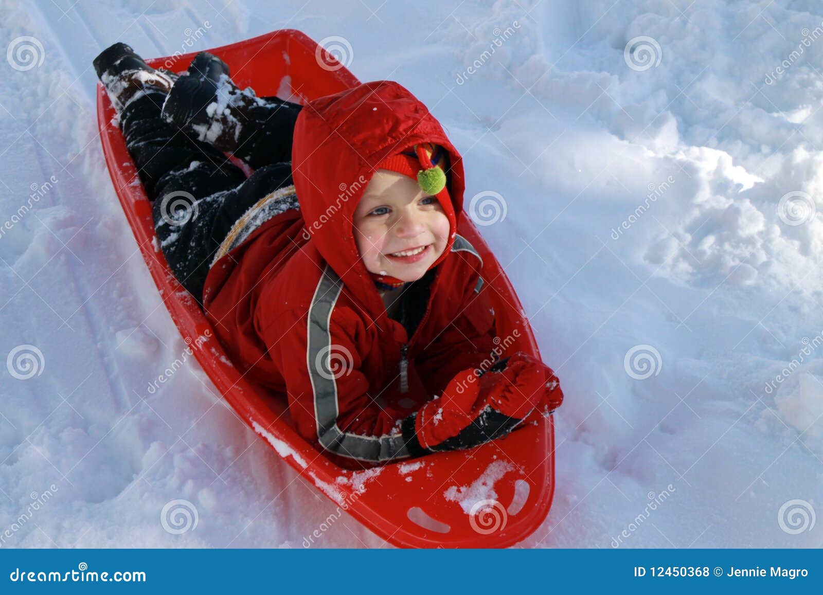 toddler boy sledding snow 12450368