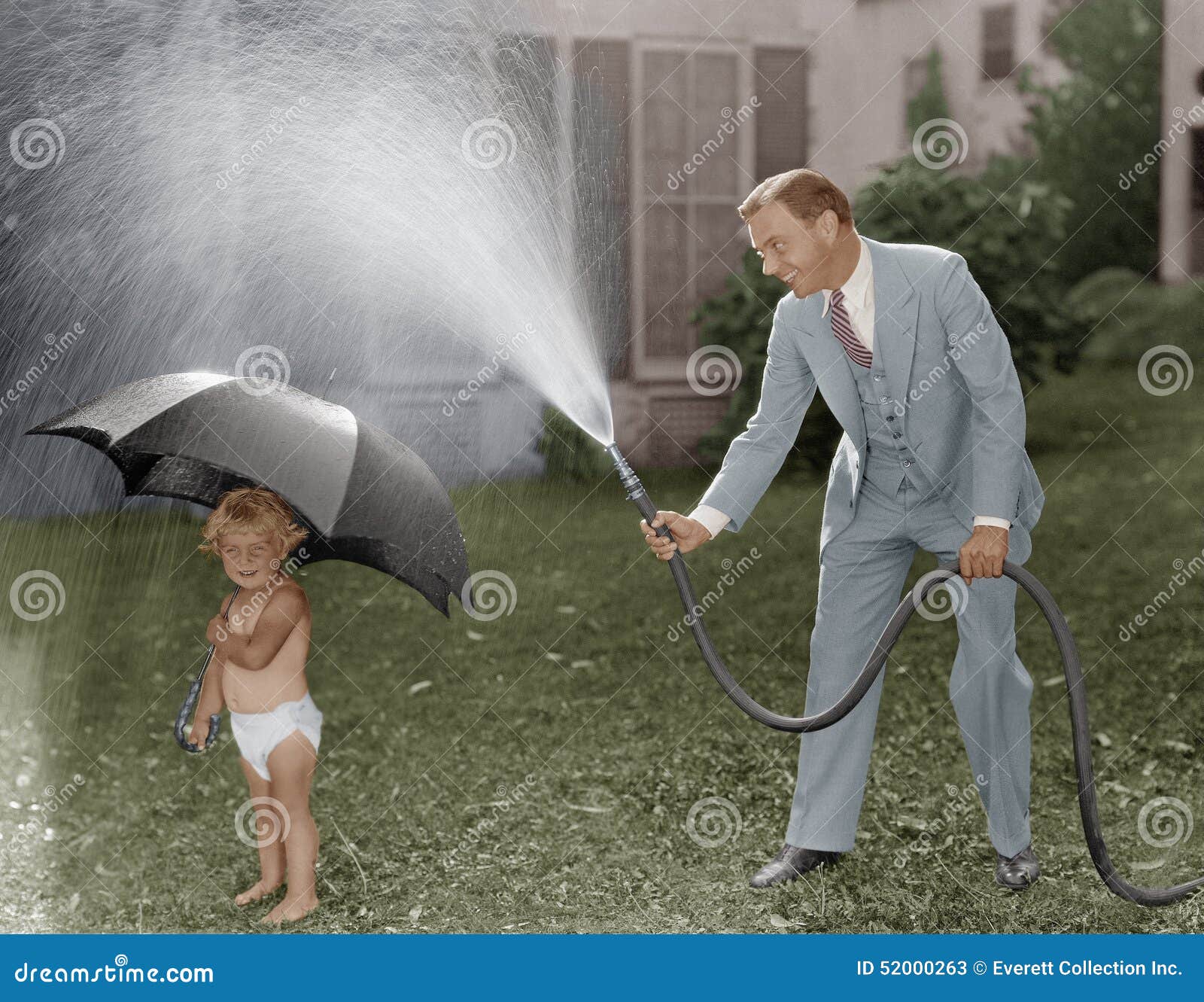 Toddler and Dad Playing with Hose in Yard Stock Image Image of