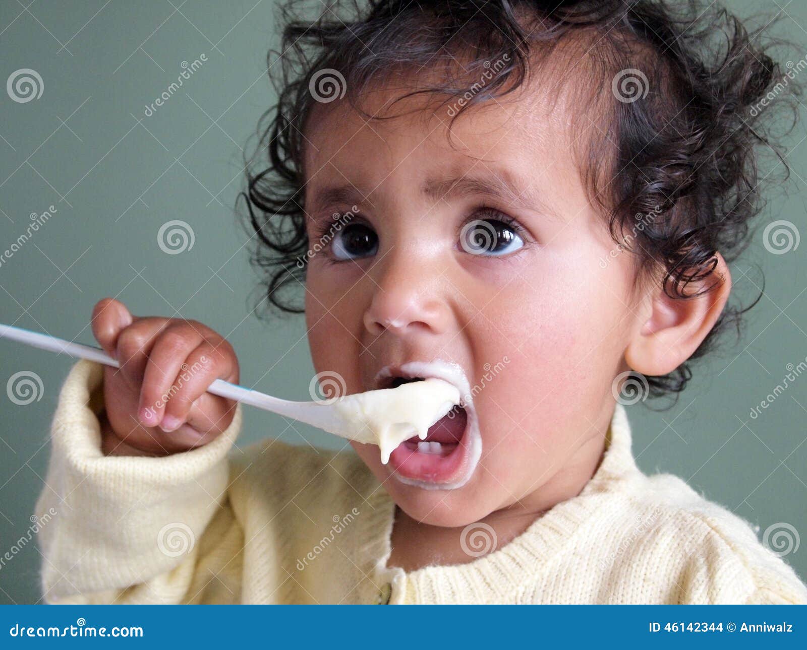Toddler Girl Feeding Herself With A Spoon Of Porridge Stock Ph