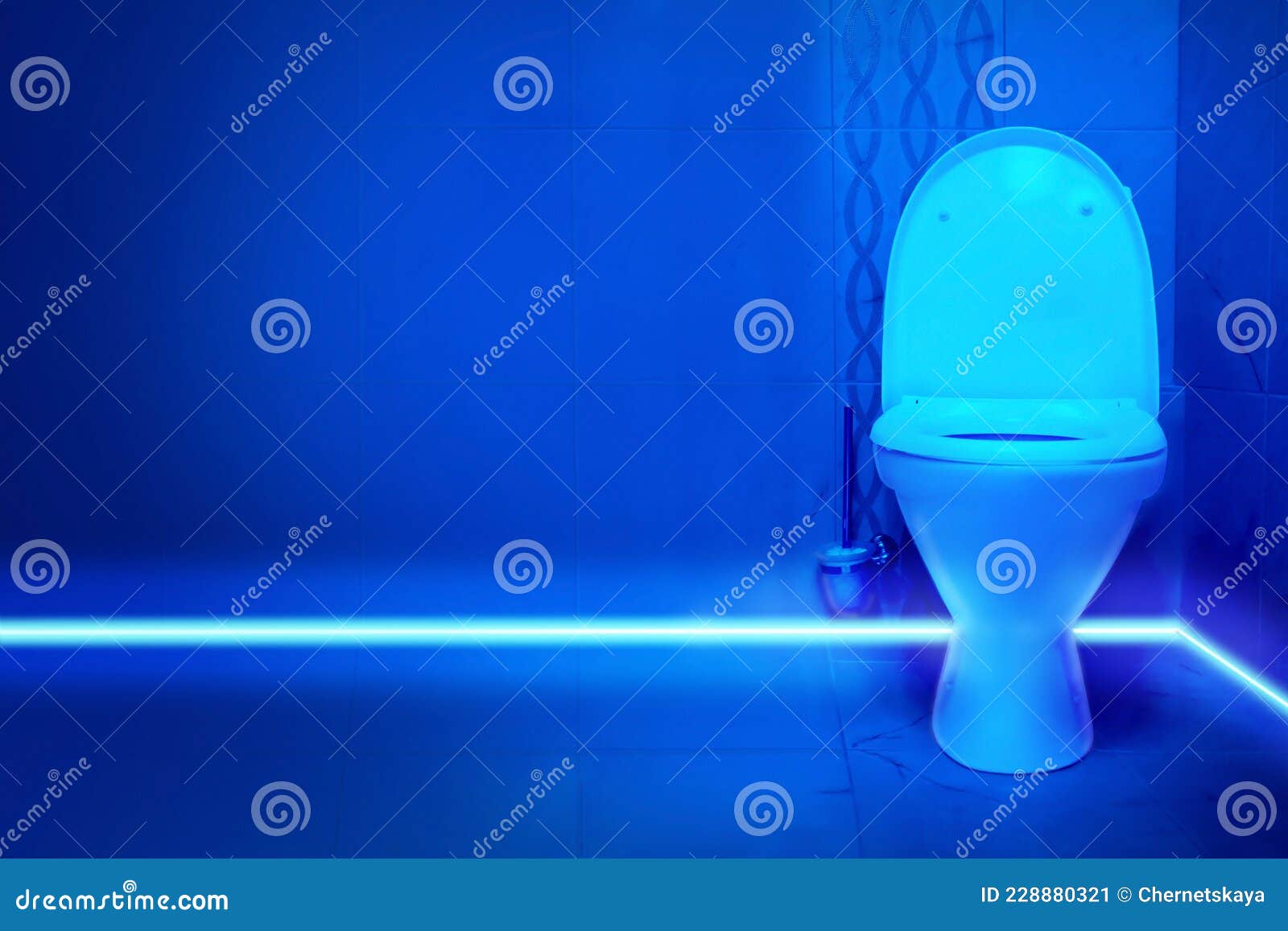 Toilet Bowl in Public Restroom Lit with UV Blue Light Stock Image