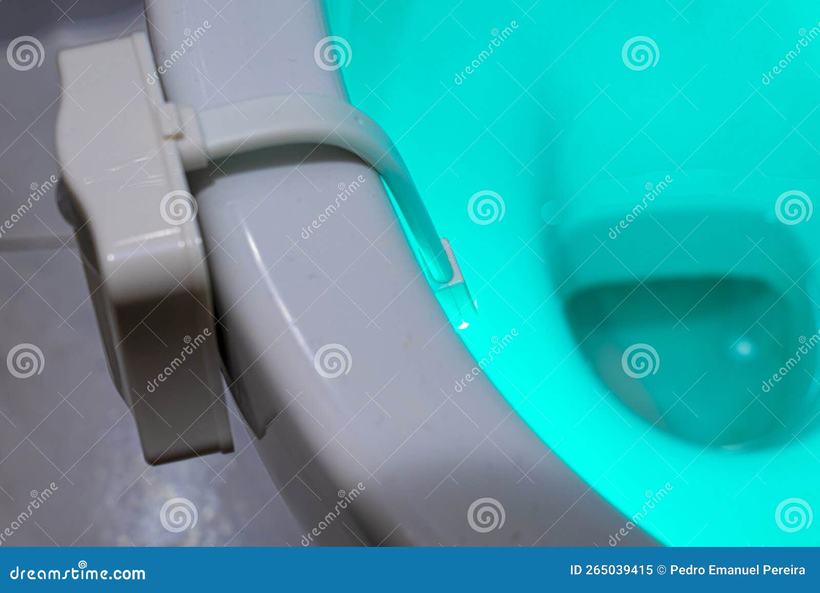 Toilet Illuminated with Green Light Inside by Means of a Device