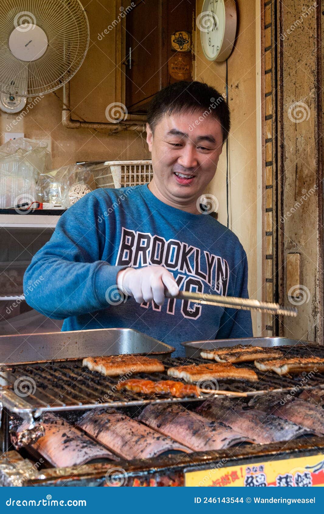 Close-up Japanese Street Food Vendor Man Grilling Seafood Snacks At