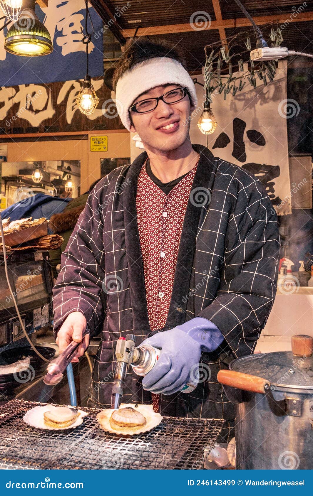 Japanese Street Food Vendor Grilling Oyster at Tsukiji Market in Tokyo