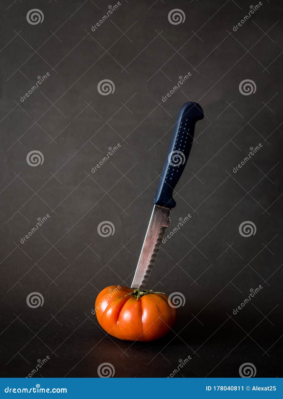 Tomato with knife on black stock image. Image of chopping 178040811
