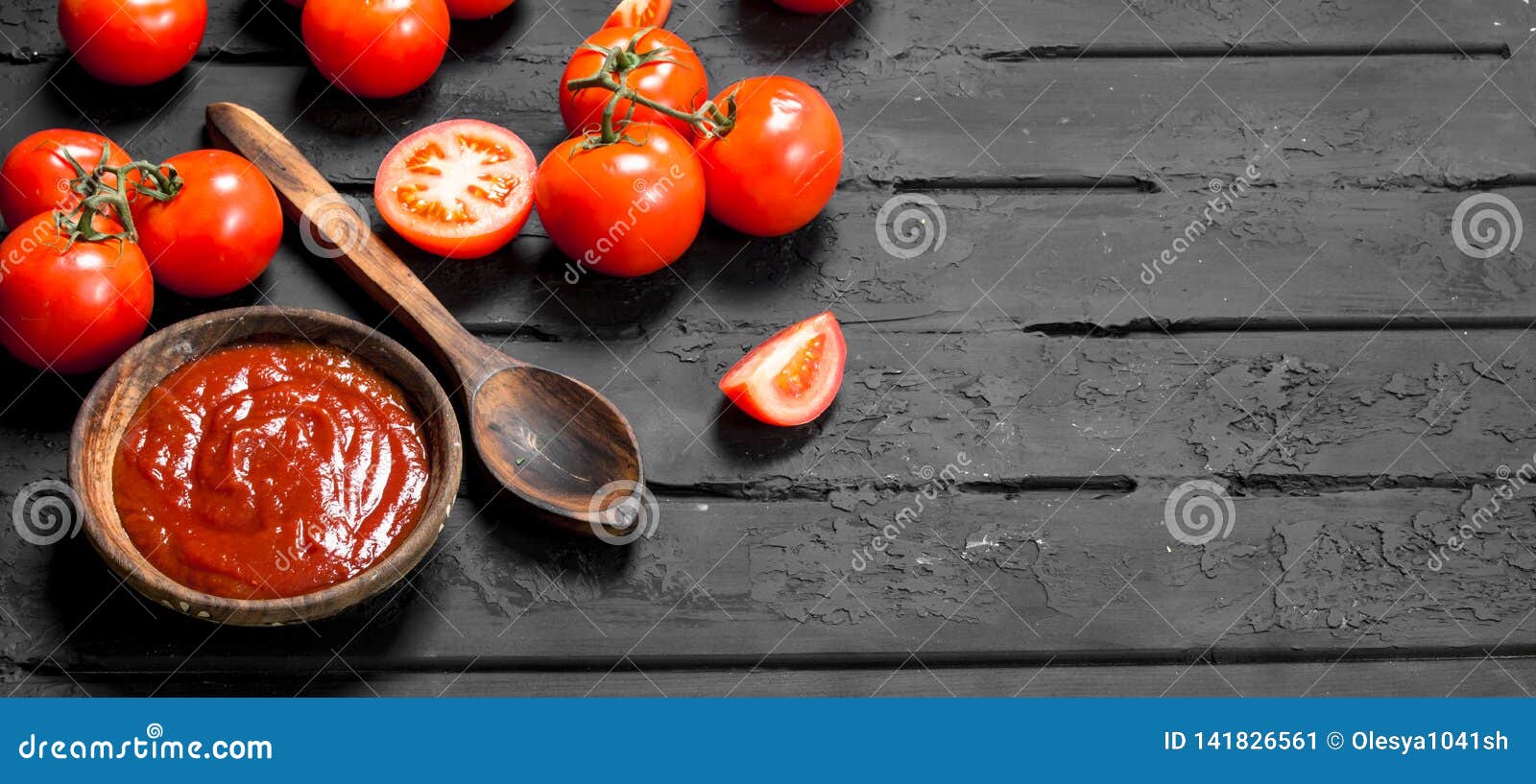 Tomato Sauce in Bowl with Spoon and Slices of Ripe Tomatoes Stock Image