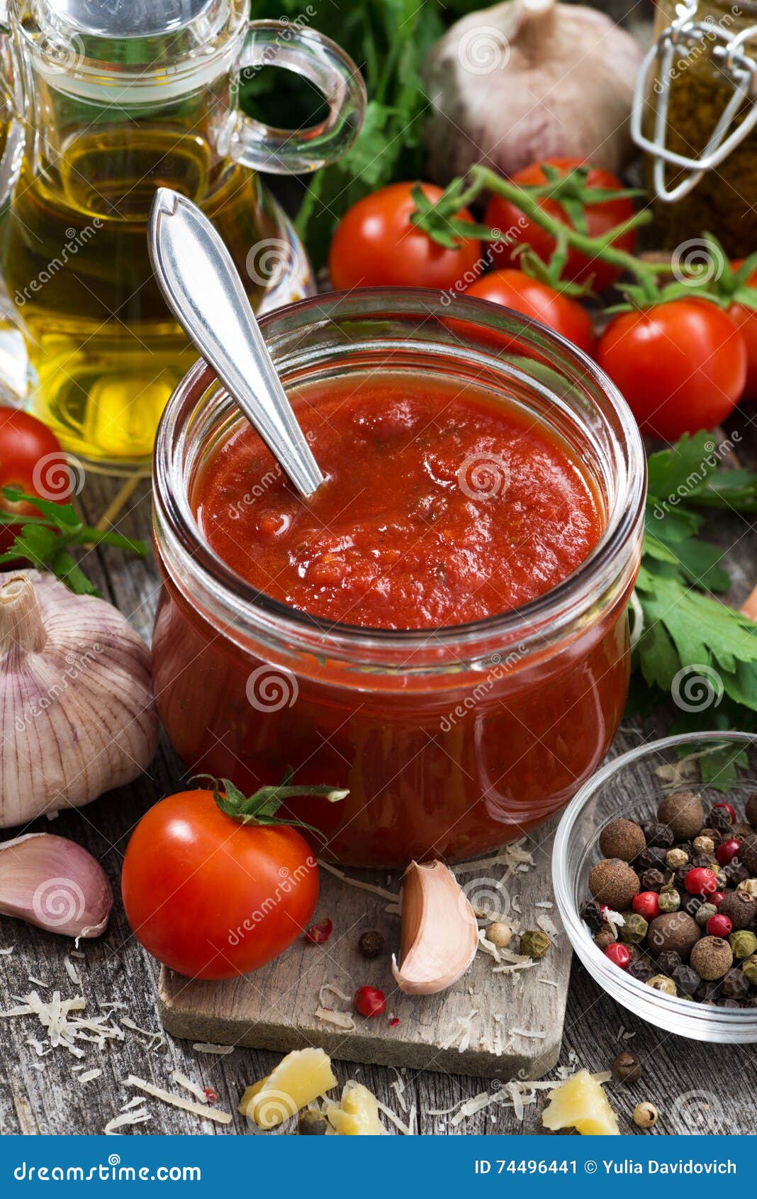 Tomato Sauce in a Glass Jar and Fresh Ingredients, Vertical Stock Image