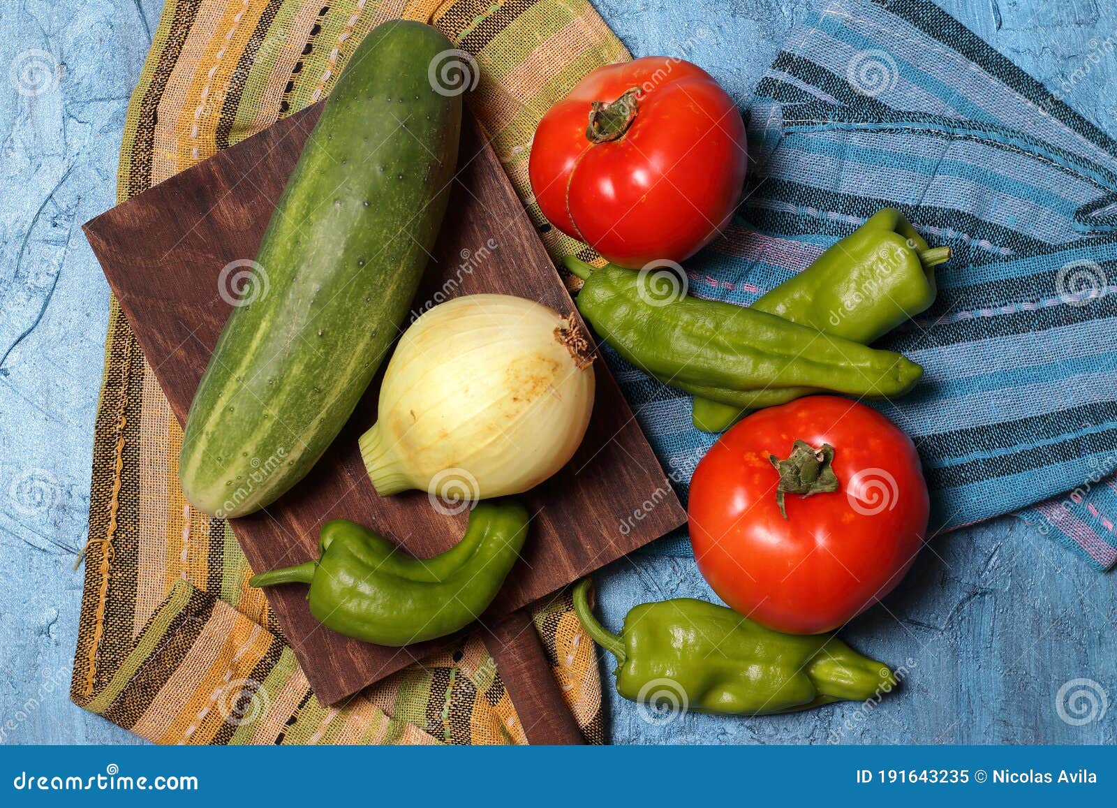tomatoes, zucchini, onion and pepper and wooden board