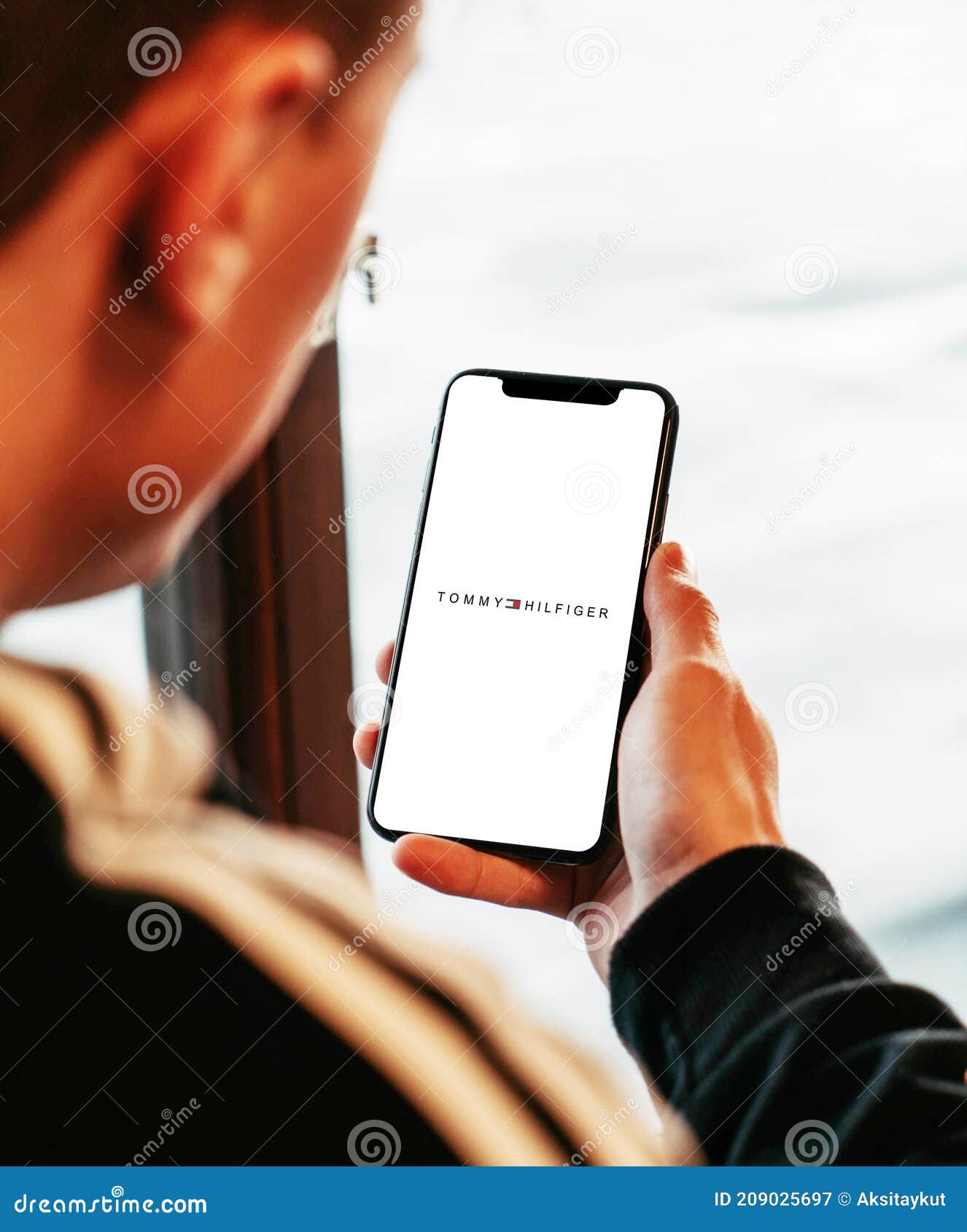 Tommy Hilfiger on Iphone in Hand Realistic Texture Editorial Photography -  Image of designing, career: 209025697
