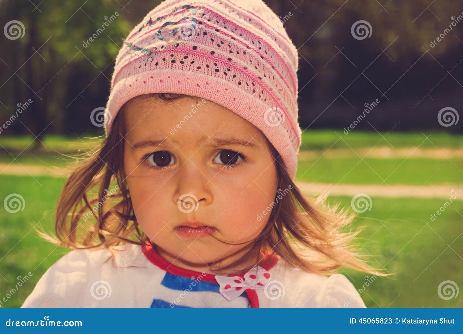 Toned Portrait of Cute Little Kid Thinking at the Park Stock Image