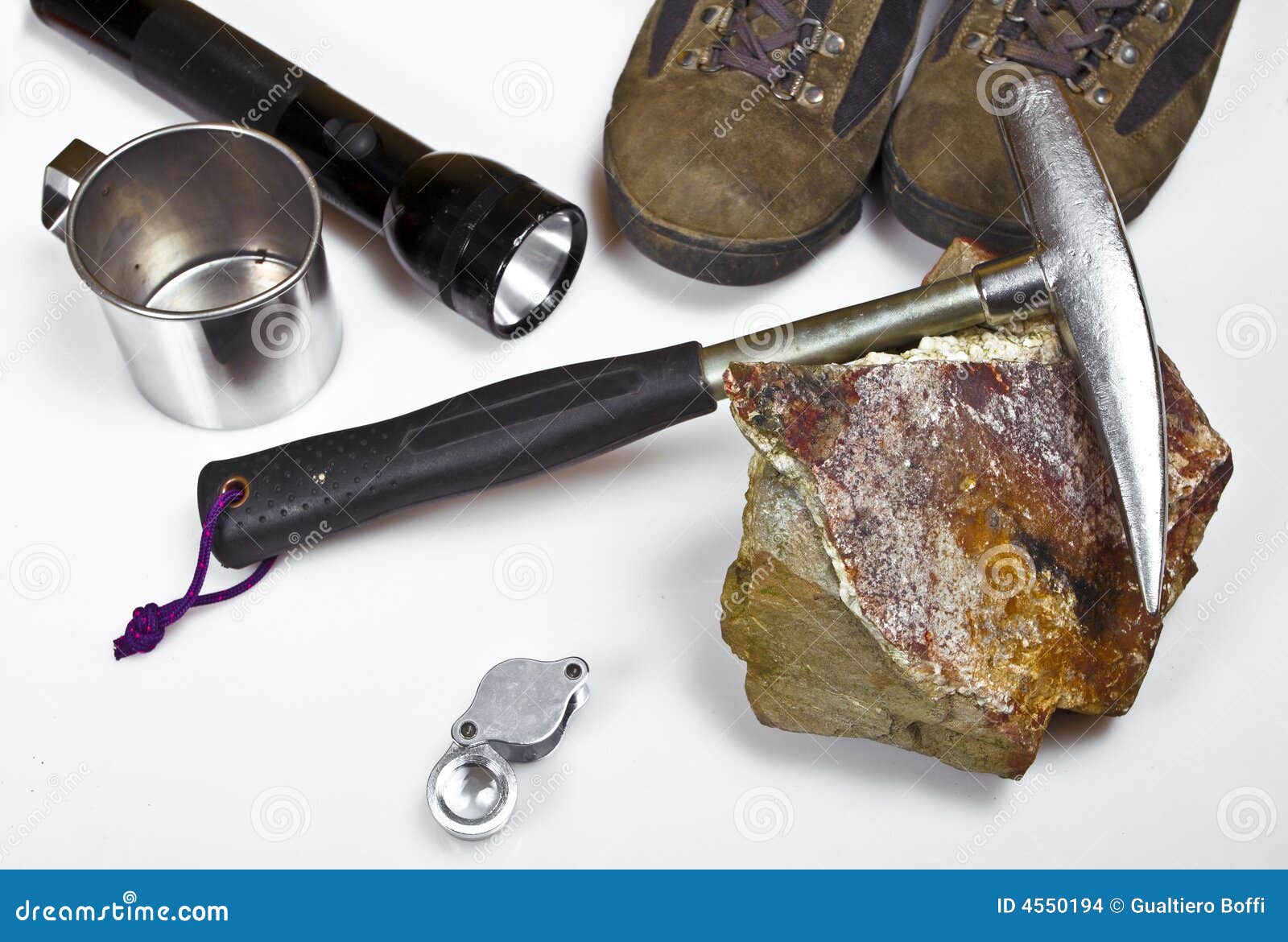 Tools of adventure. Shoes hammer light mug lens and stone