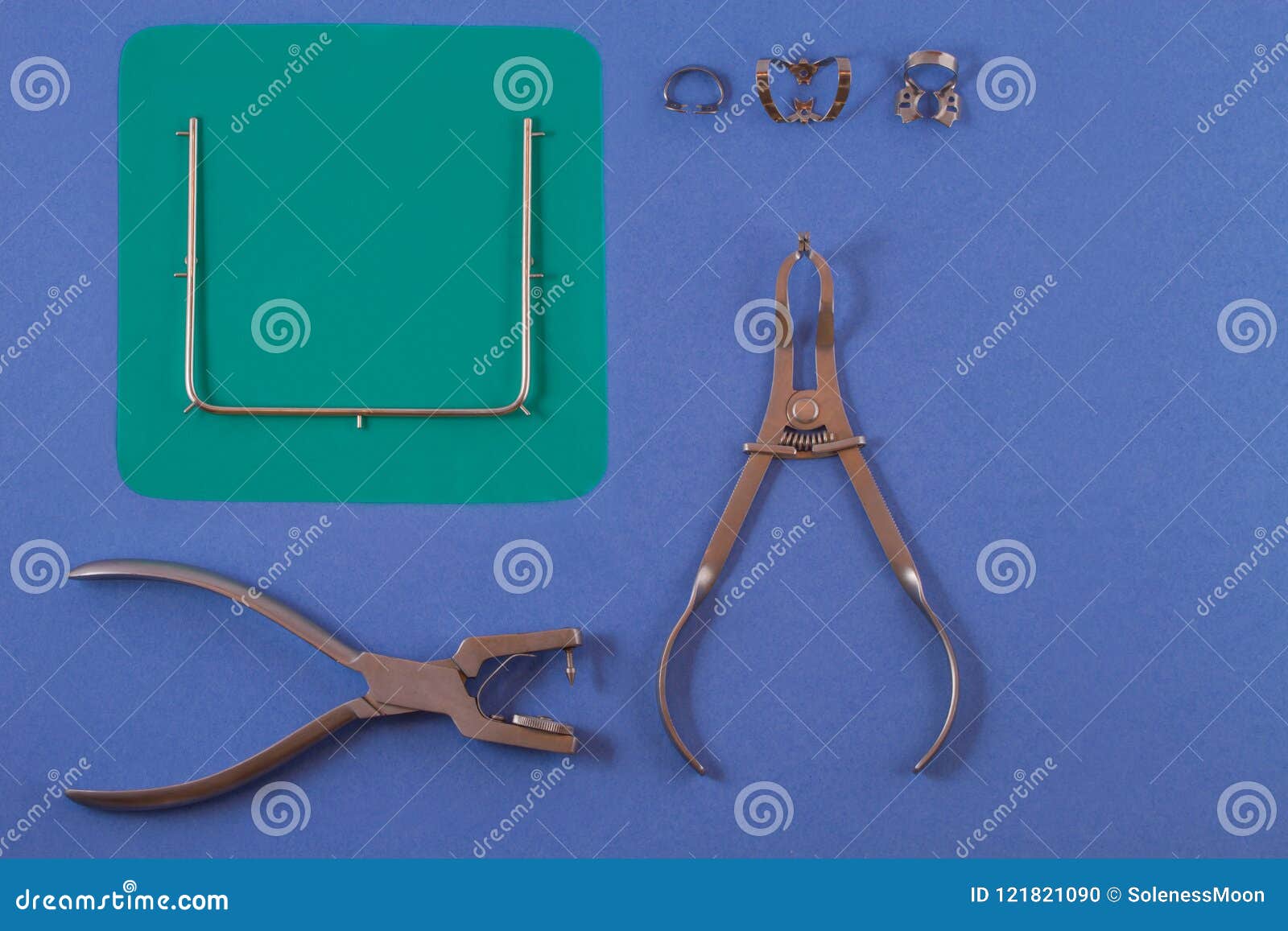 tools for installing the cofferdam lying on a blue background.