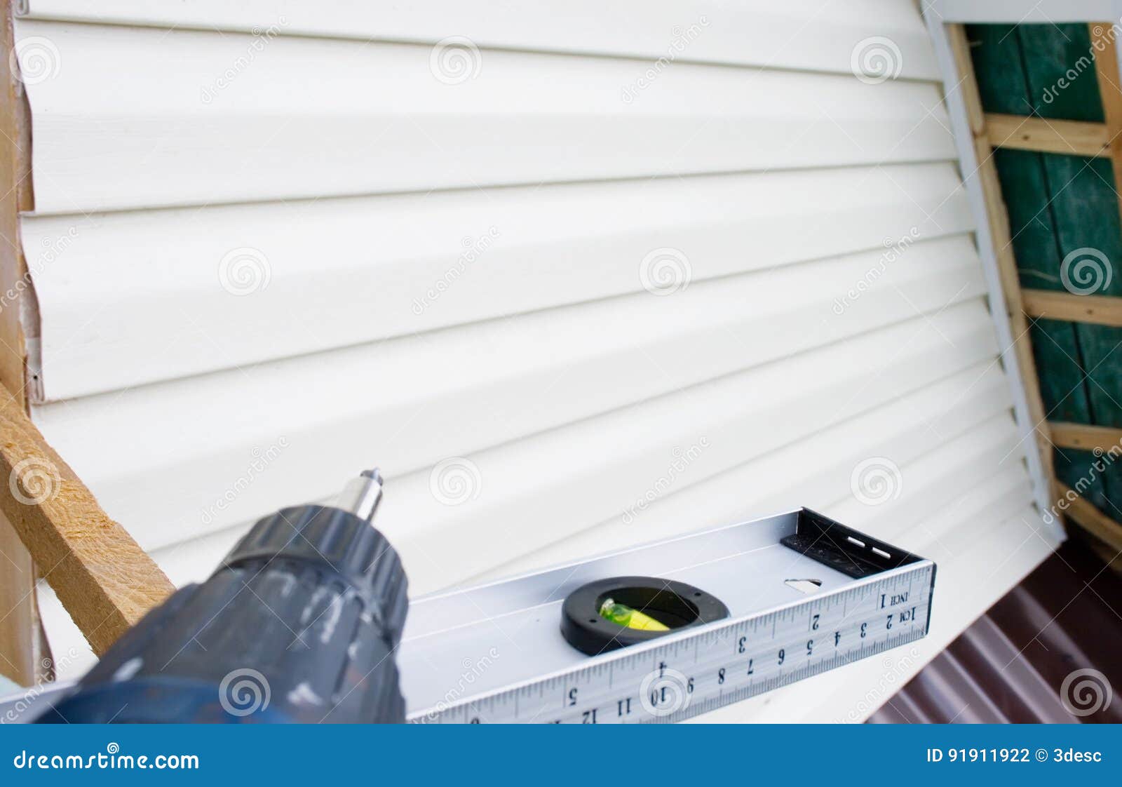 Tools for Mounting the Siding, Screwdriver and Level Stock Photo