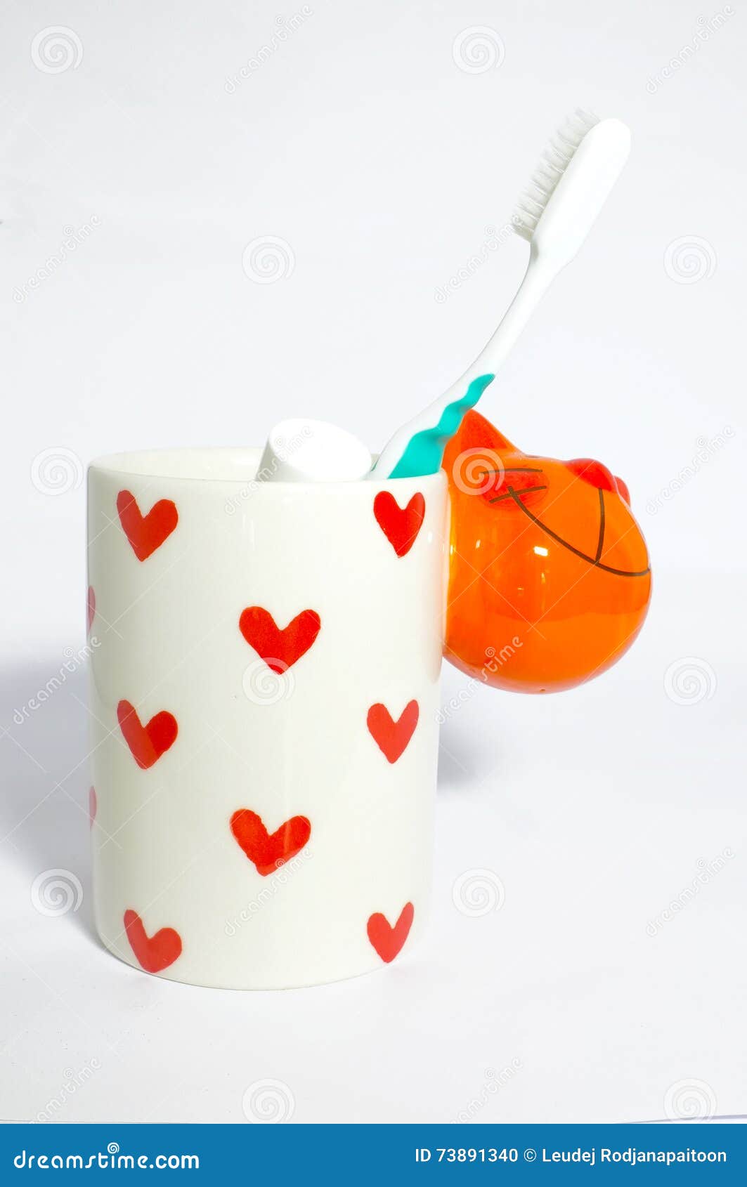 Toothbrush in ceramic mug stock photo. Image of heart 73891340