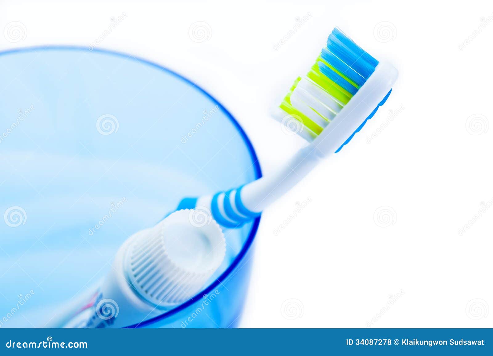 Toothbrush and Toothpaste in Blue Plastic Glass Stock Photo Image of