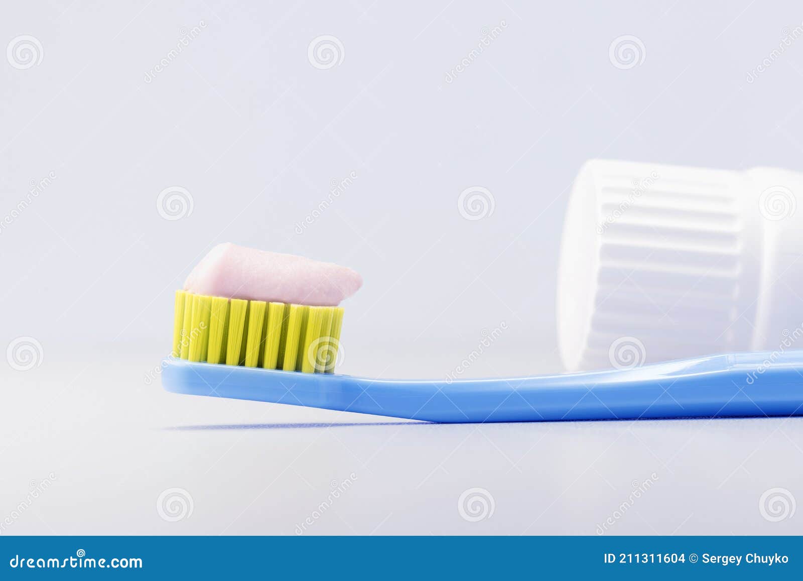 Toothbrush with Toothpaste on Grey Background. Stock Photo Image of