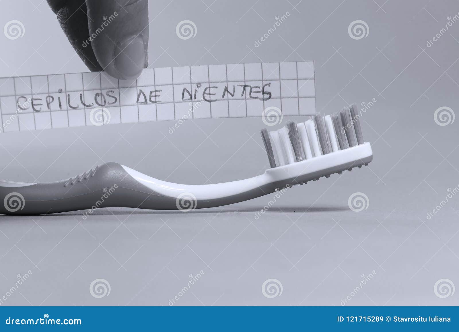 toothbrush written on a small paper, cepillos de dientes in spanish