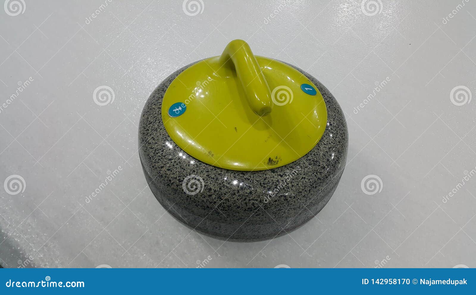 Top Angular View of a Curling Stone on White Slippery Ice Stock Photo