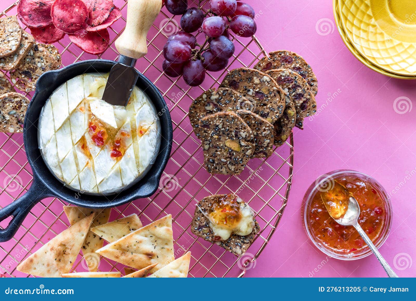 Top Down View of Baked Brie Served with Assorted Crackers and Red