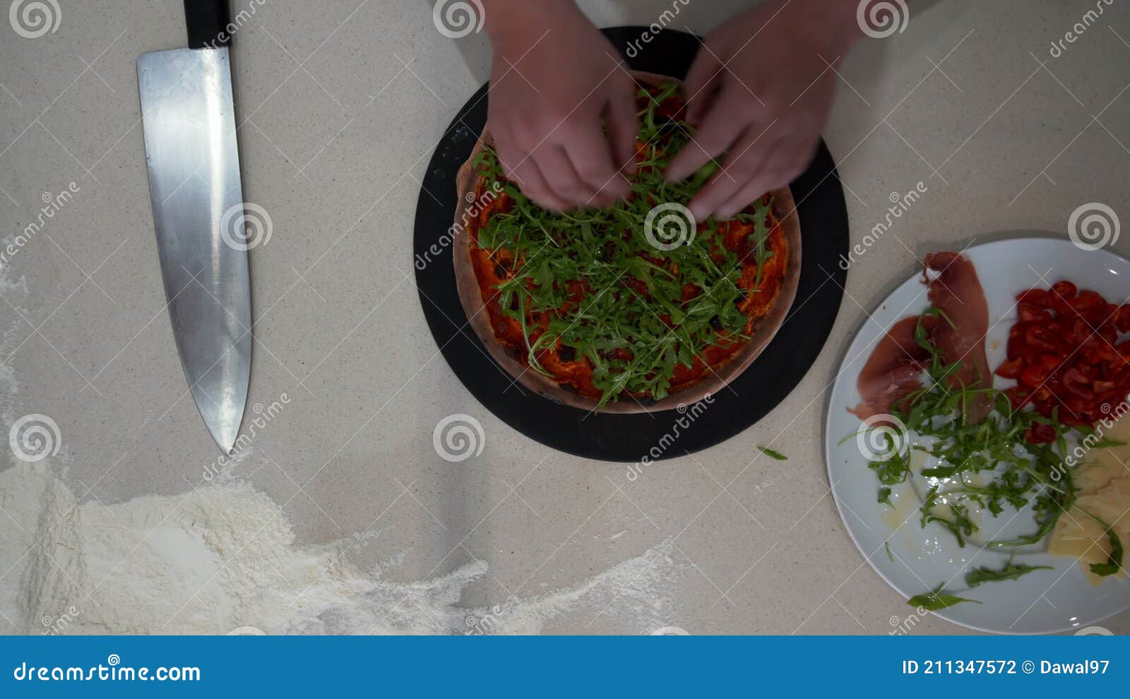 Top Down View of a Chef Making Pizza with Various Condiments. Overhead