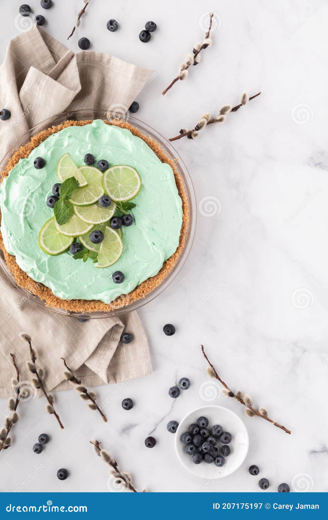 Top Down View of a Key Lime Pie Garnished with Lime and Blueberries and