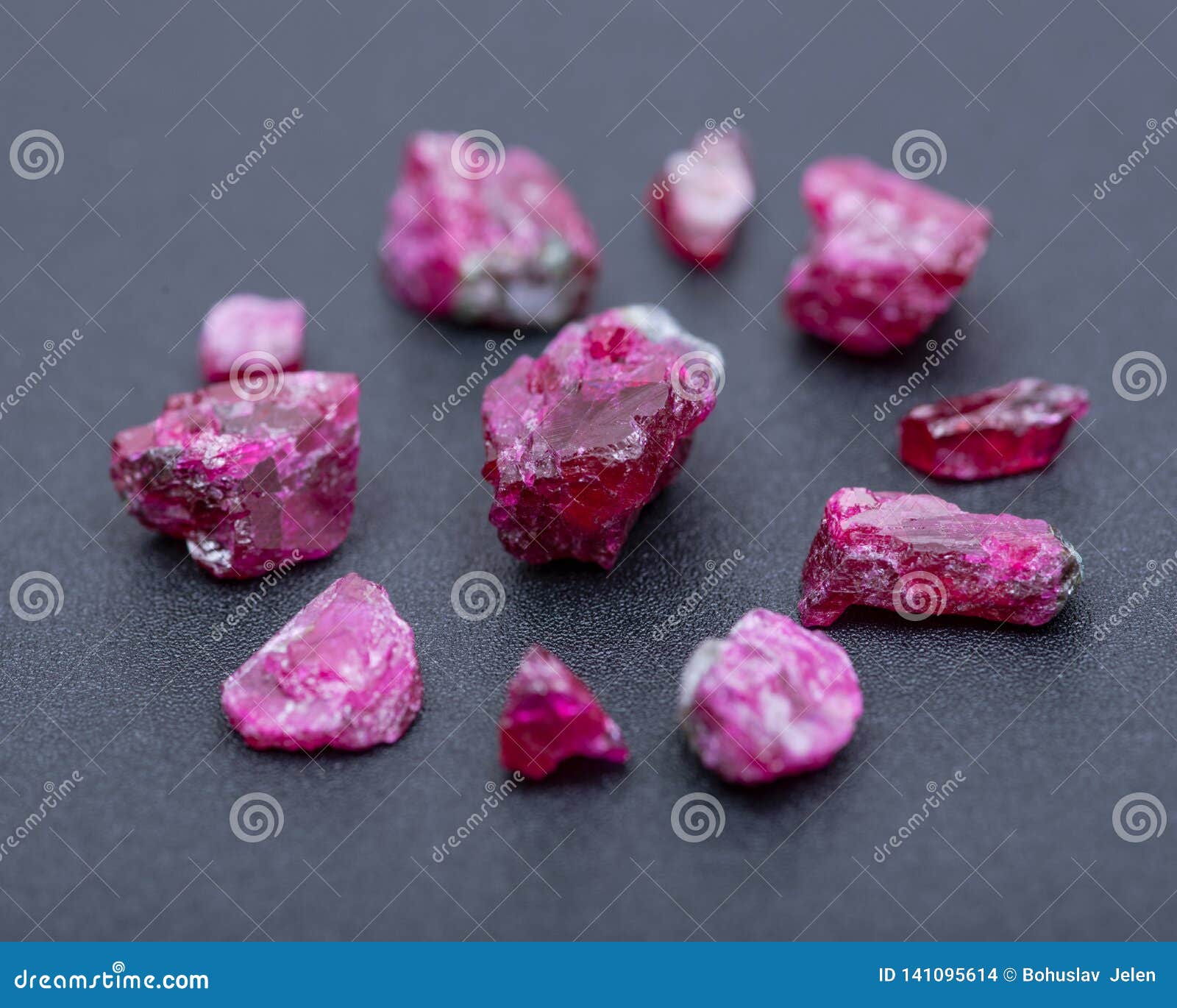 top quality a grade small rough ruby crystals from tanzania on black. red corundum.