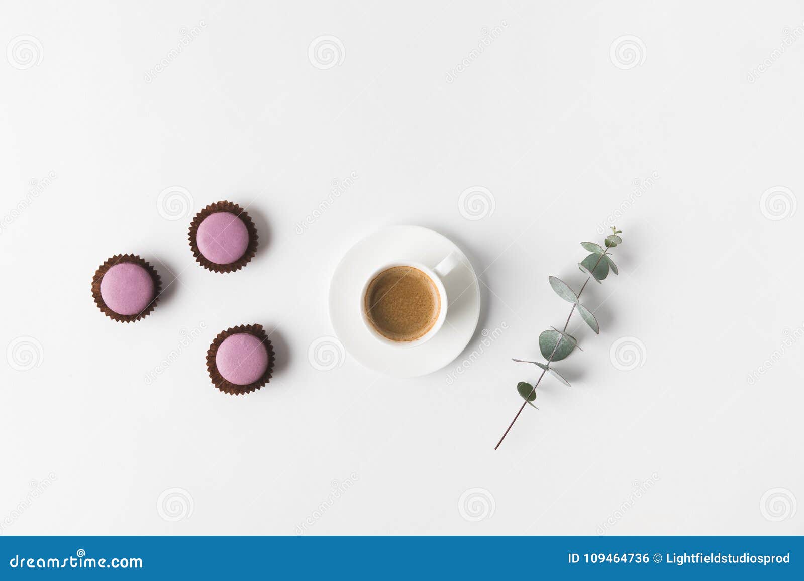 arranged cup of coffee, desserts and plant on white tabletop