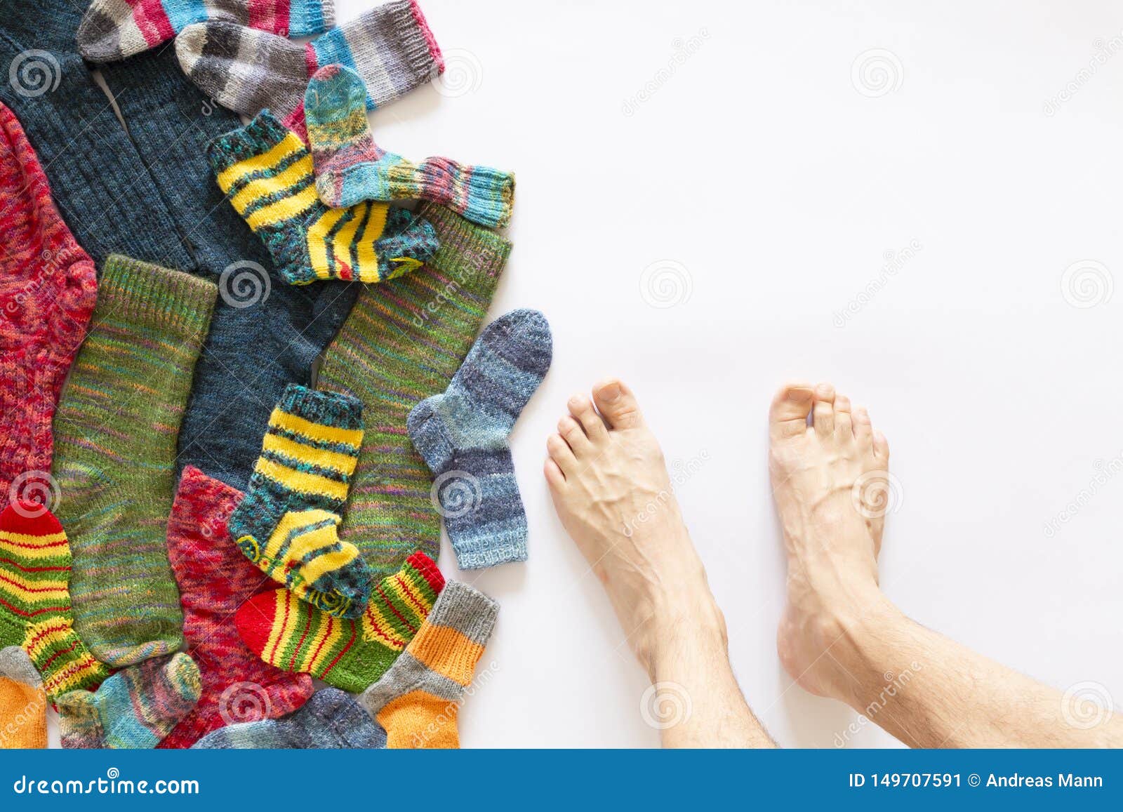 Colorful Woolen Socks And A Pair Of Legs On White Background Stock