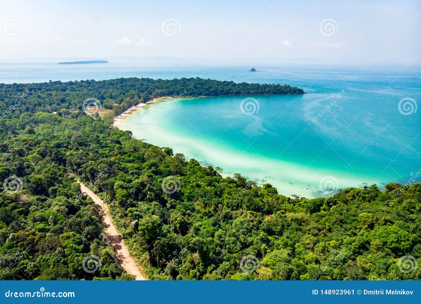 Top View Of A Beautiful Tropical Island With Dense Forest Or