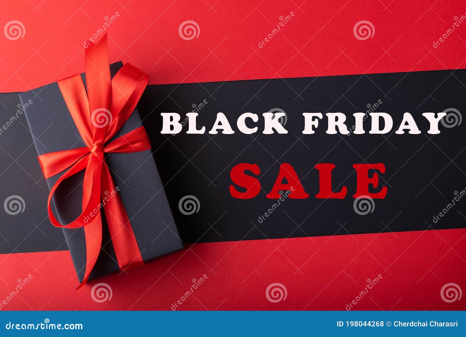 Top View of Black Boxes with Red Ribbon on Black Background and Red