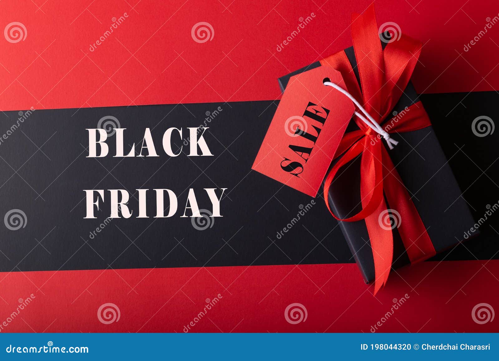 Top View of Black Boxes with Red Ribbon on Black Background and Red