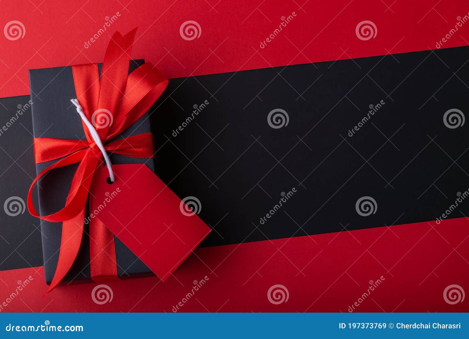 Top View of Black Boxes with Red Ribbon on Black Background and Red