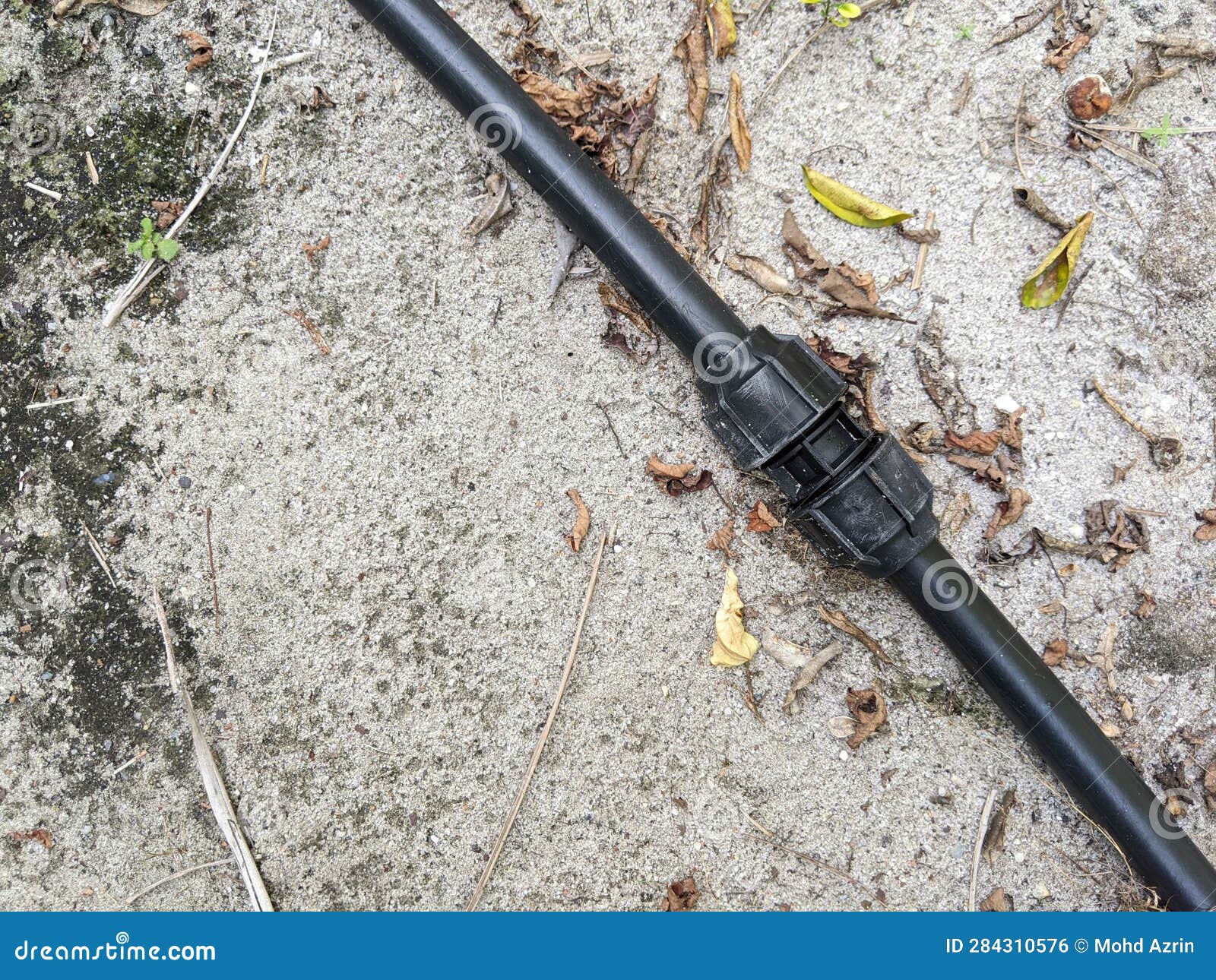 The Black Poly Pipe that is on the Ground after Being Repaired. Stock