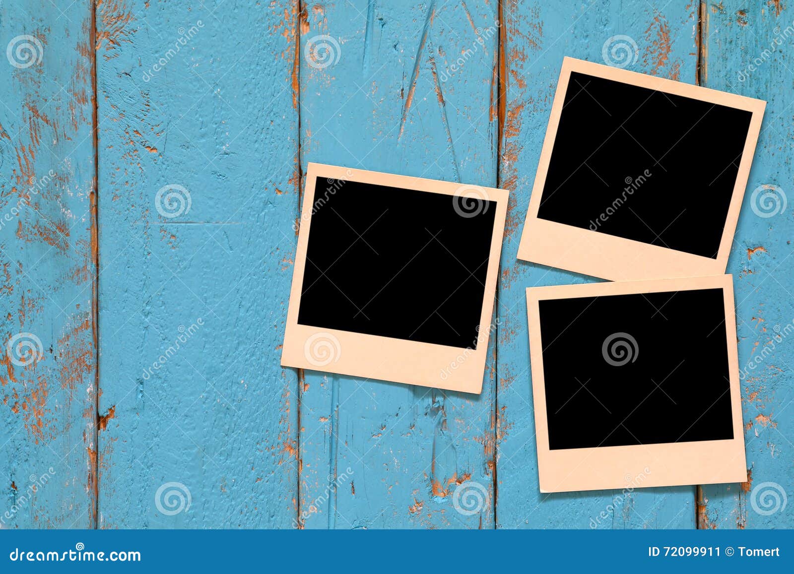 Top view of blank instant polaroid photos album on wooden blue background. vintage filtered image. ready to put images