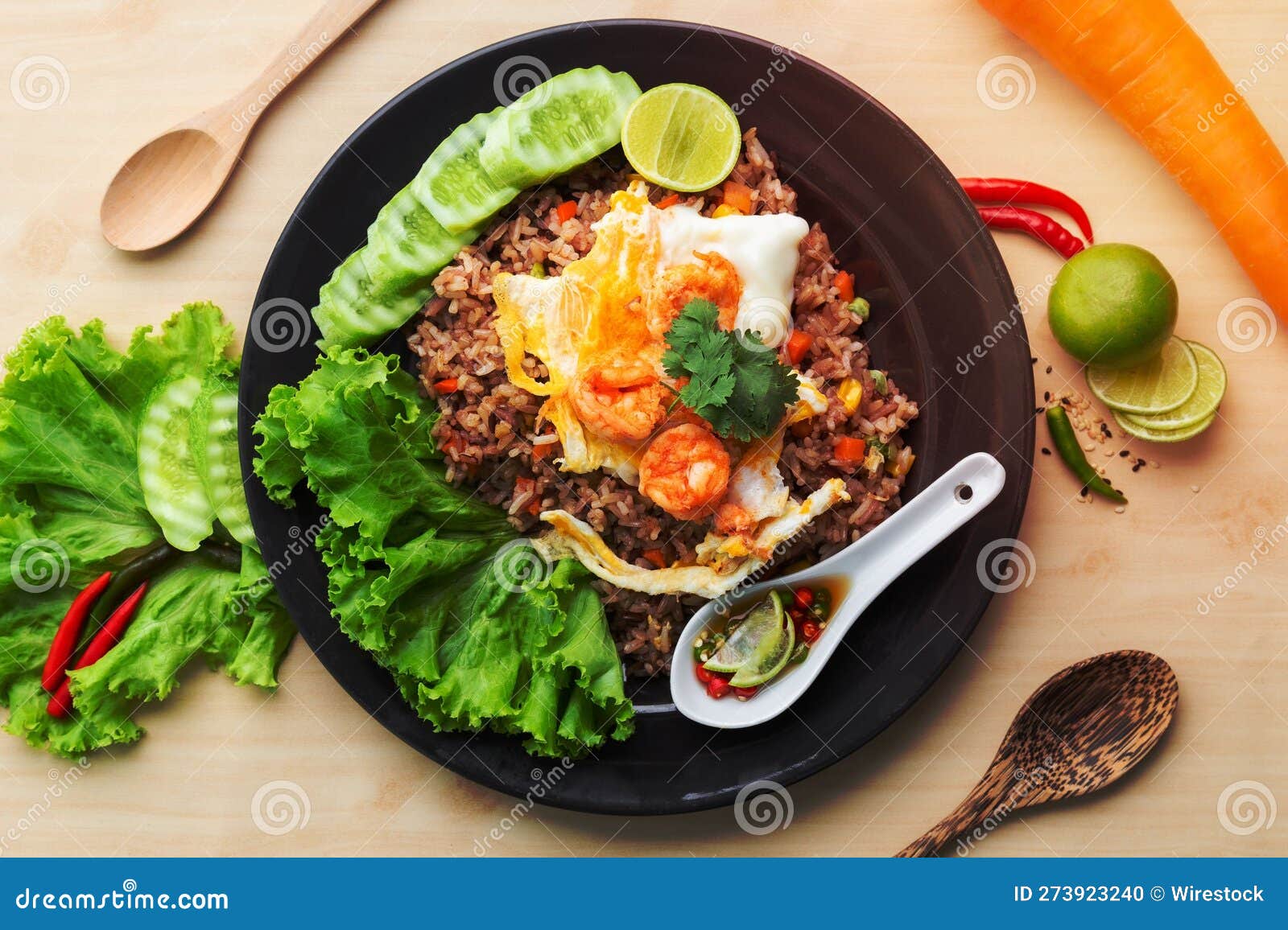 Top View of a Bowl of Fried Brown Rice with Shrimp and a Fried Egg on