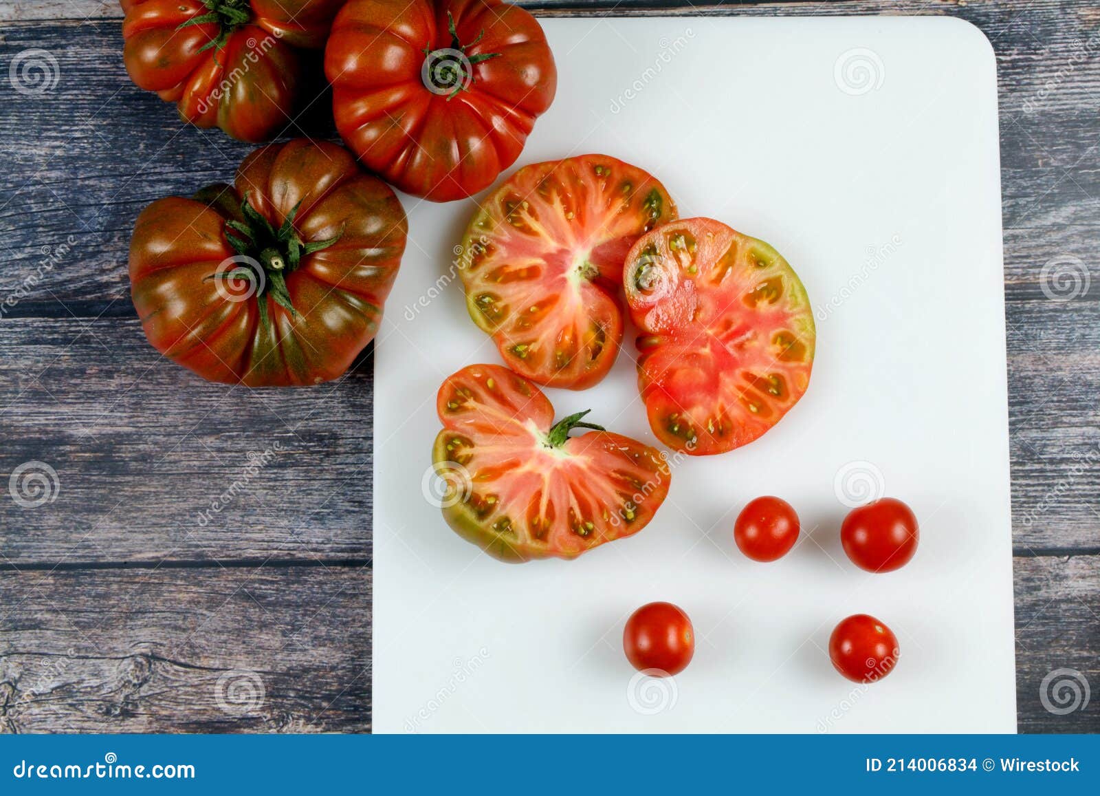 Top View of Brandywine and Cherry Tomatoes on Cutting Board Stock Photo