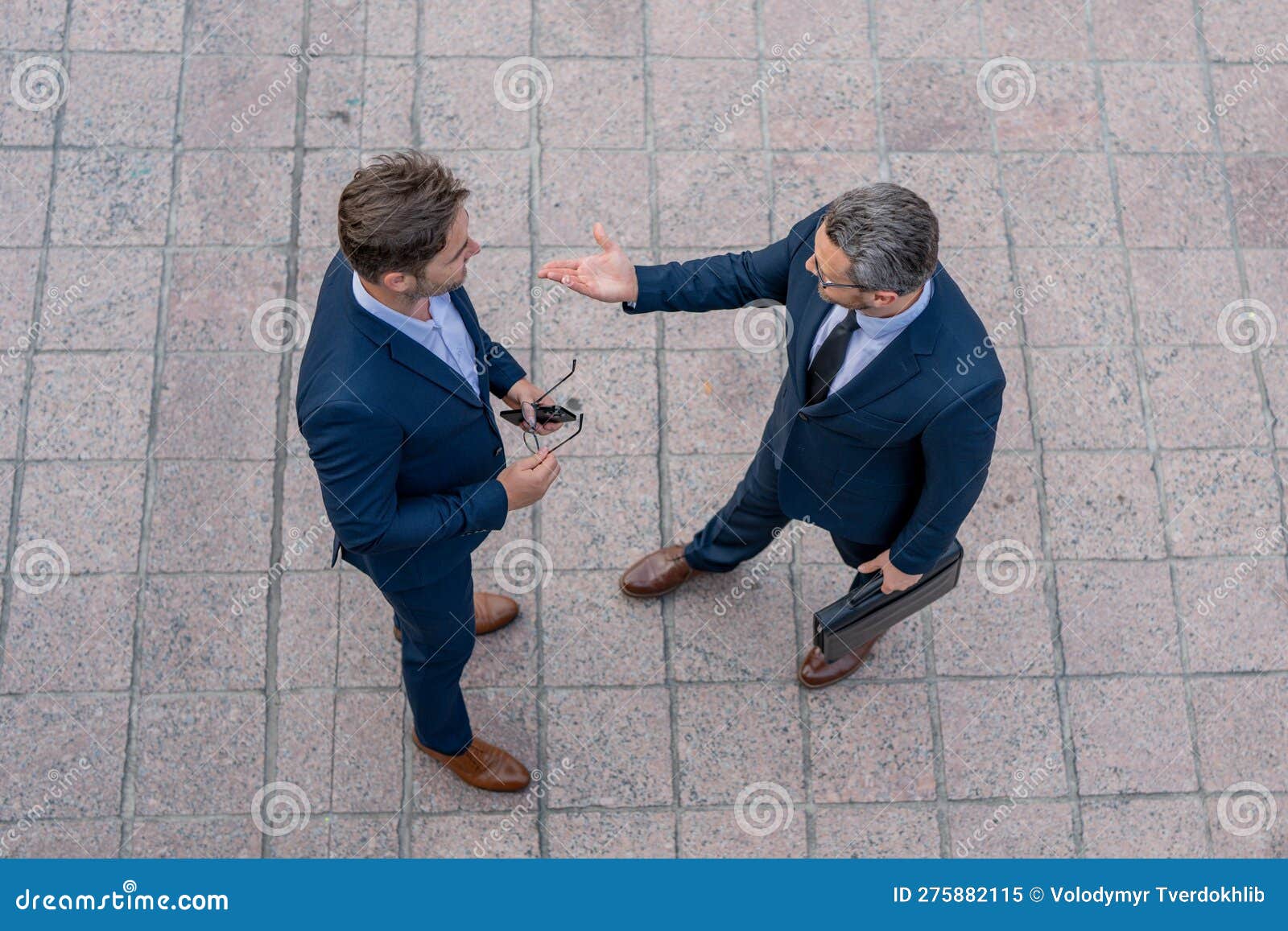 top view of business man talking on outdoor meeting. devising big plans with the boss. business partners discussing