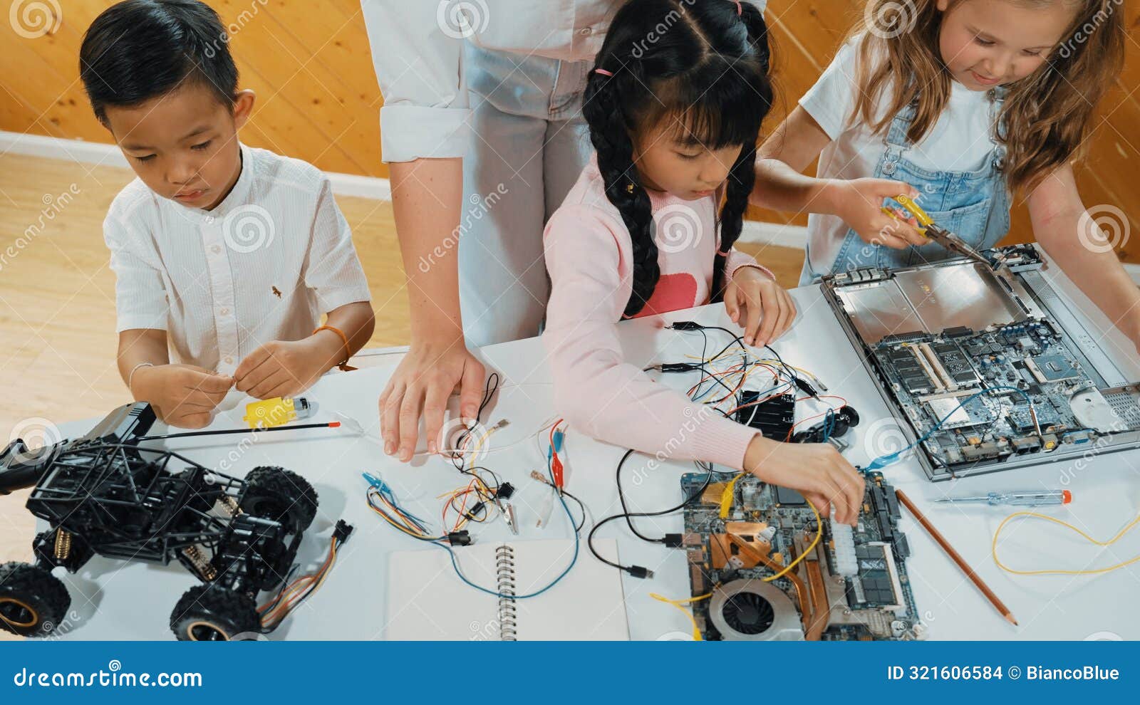 young smart teacher teaching diverse students about electronic board. erudition.