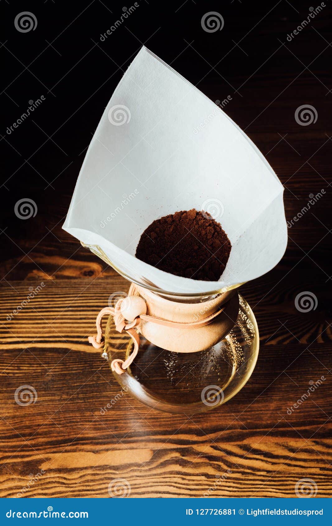 Top View of Chemex with Ground Coffee in Filter Cone on Wooden Table