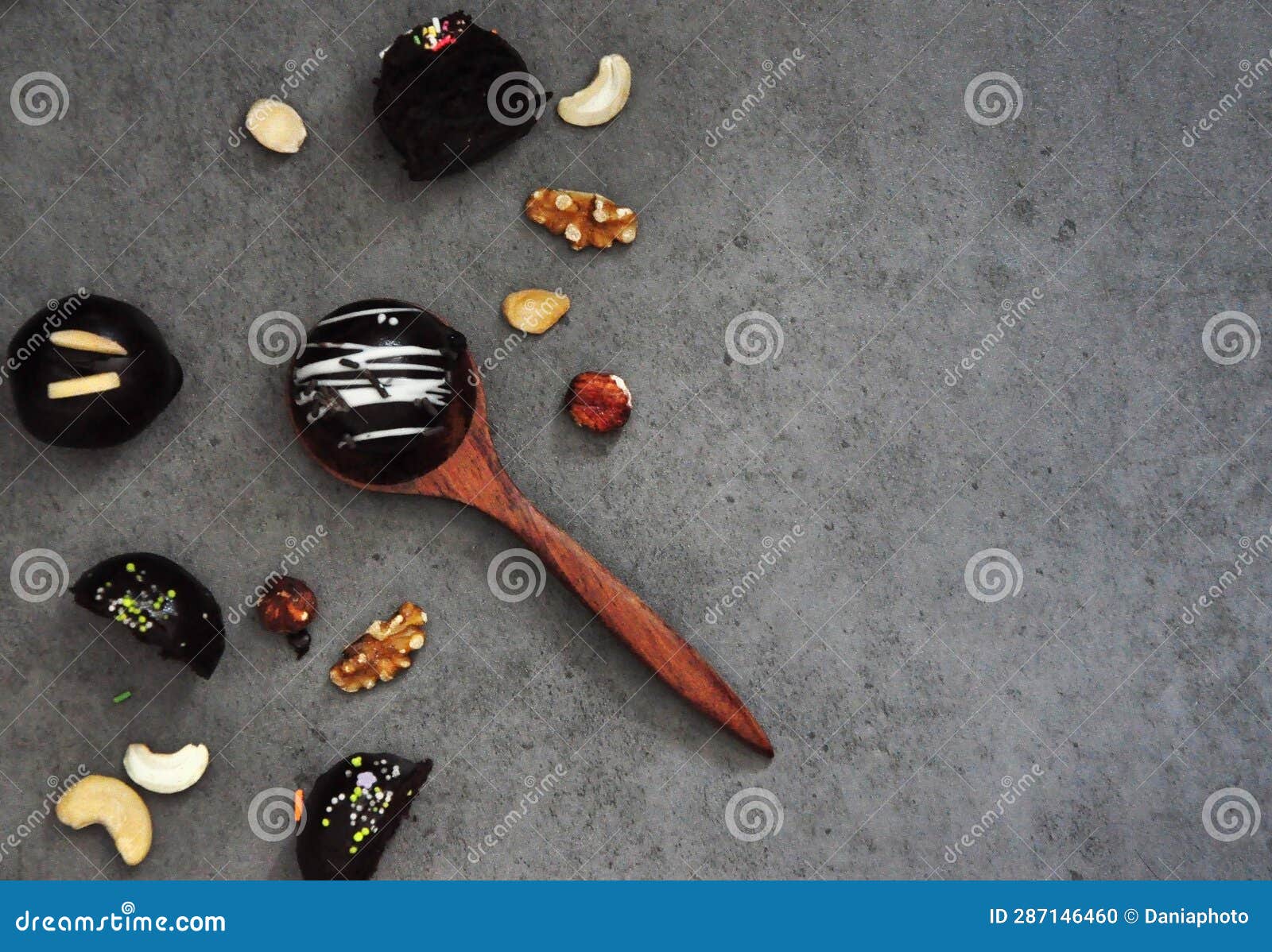 Top View of Chocolate Balls and Nuts on Grey Background Stock Photo